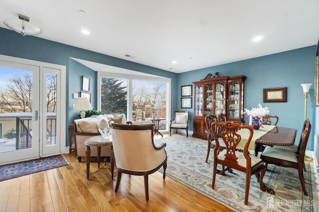 living area featuring recessed lighting, visible vents, and light wood finished floors