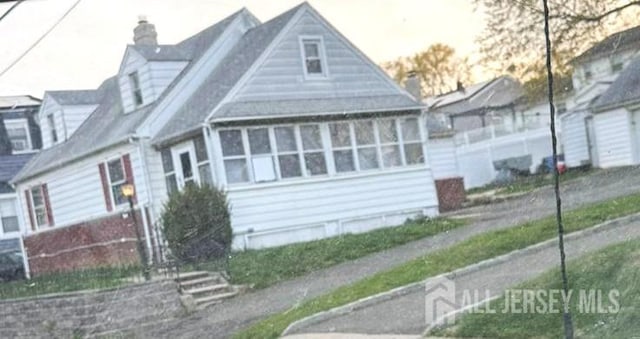 54 Clauss St, Carteret, NJ 07008 - view of front of home with a chimney