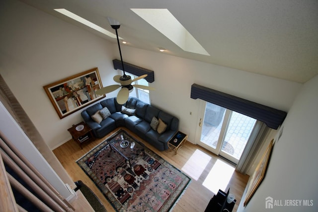 124 Chichester Rd, Monroe, NJ 08831 - living area with a skylight, vaulted ceiling, wood finished floors, healthy amount of natural light, and a ceiling fan