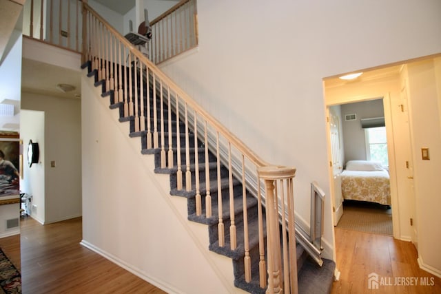 124 Chichester Rd, Monroe, NJ 08831 - stairs featuring wood finished floors, baseboards, and a towering ceiling