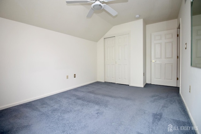 124 Chichester Rd, Monroe, NJ 08831 - unfurnished bedroom with dark carpet, baseboards, a closet, and vaulted ceiling