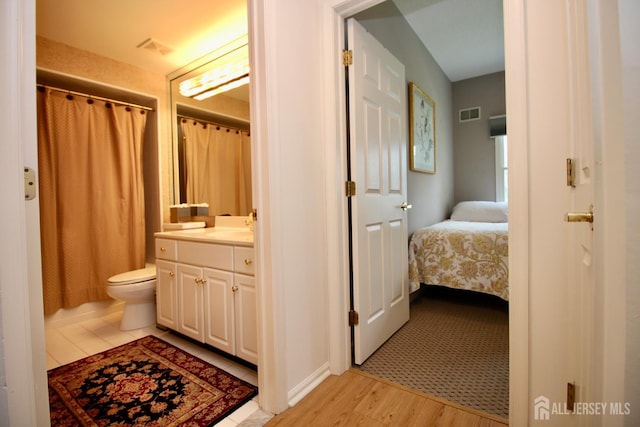 124 Chichester Rd, Monroe, NJ 08831 - bathroom with vanity, wood finished floors, toilet, connected bathroom, and a shower with curtain