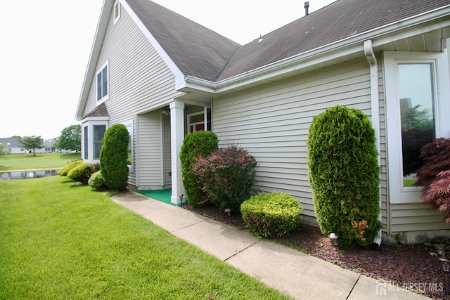 124 Chichester Rd, Monroe, NJ 08831 - view of property exterior featuring a yard, roof with shingles, and a water view