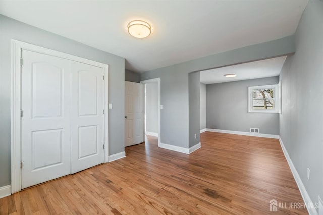 48 Columbus Ave, Edison, NJ 07008 - unfurnished bedroom featuring wood finished floors, baseboards, and a closet