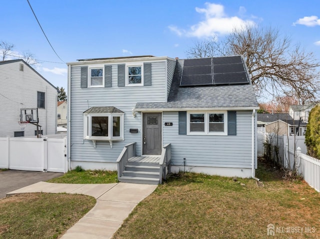 48 Columbus Ave, Edison, NJ 07008 - traditional home with roof mounted solar panels, a shingled roof, and a gate