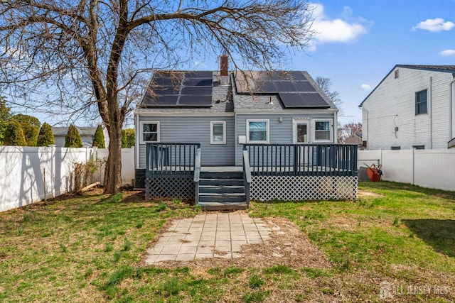 48 Columbus Ave, Edison, NJ 07008 - back of property with a chimney, a wooden deck, and solar panels