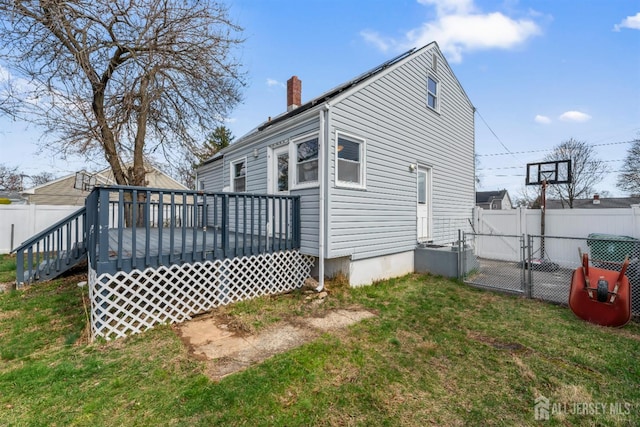 48 Columbus Ave, Edison, NJ 07008 - back of property featuring a chimney, a wooden deck, and a gate