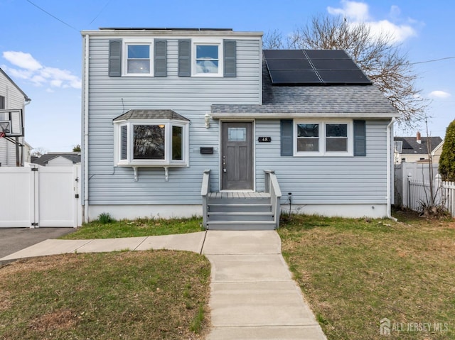 48 Columbus Ave, Edison, NJ 07008 - view of front facade with a gate, solar panels, and a shingled roof
