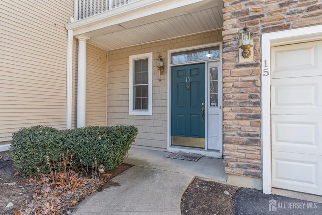 property entrance with stone siding