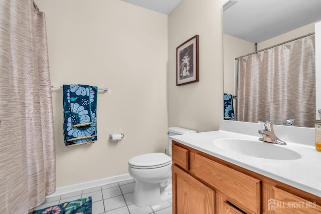 bathroom with tile patterned flooring, toilet, baseboards, and vanity