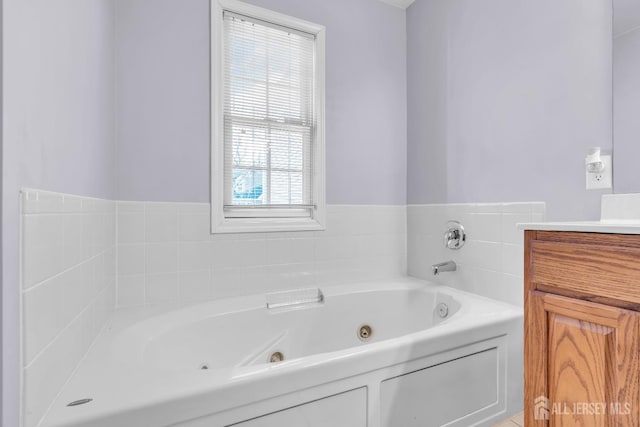 bathroom featuring a tub to relax in, plenty of natural light, and vanity