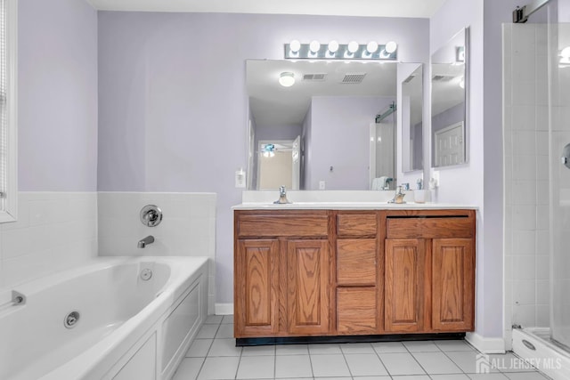 bathroom with tile patterned flooring, shower with separate bathtub, and vanity