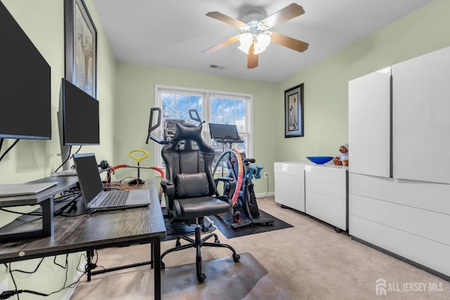exercise area with ceiling fan and carpet flooring