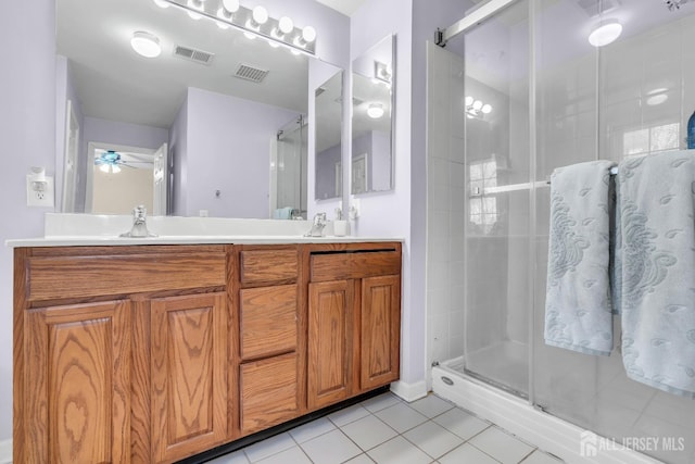 full bath with tile patterned flooring, a shower stall, ceiling fan, and double vanity
