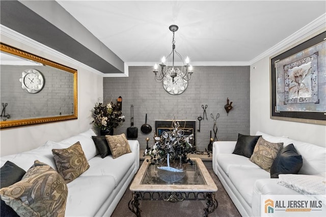 living room featuring ornamental molding, a brick fireplace, a notable chandelier, and brick wall