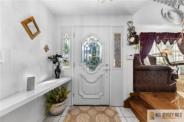 foyer entrance with light tile patterned flooring