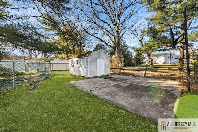 view of yard featuring a storage unit and basketball court