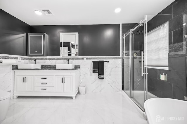 1004 Antoinette Dr, Monroe, NJ 08831 - full bathroom featuring tile walls, double vanity, a stall shower, a freestanding tub, and recessed lighting