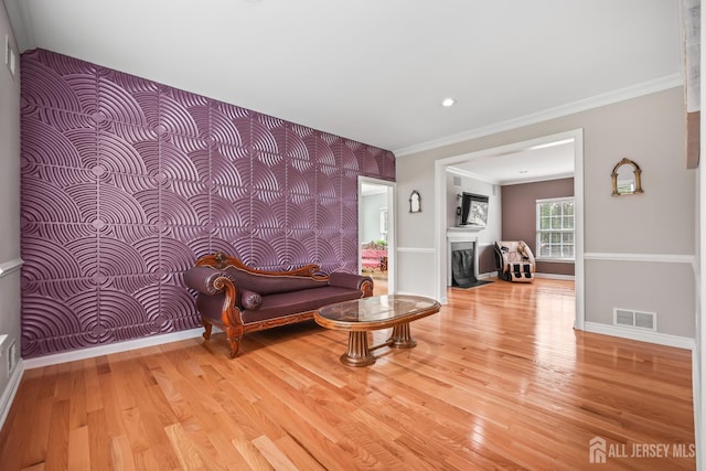 1004 Antoinette Dr, Monroe, NJ 08831 - living area with light wood-type flooring, crown molding, a fireplace, recessed lighting, and an accent wall
