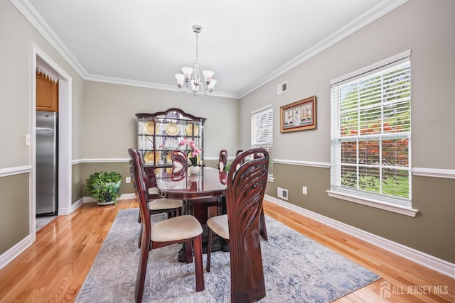 1004 Antoinette Dr, Monroe, NJ 08831 - dining area featuring a chandelier, crown molding, and light wood-style floors