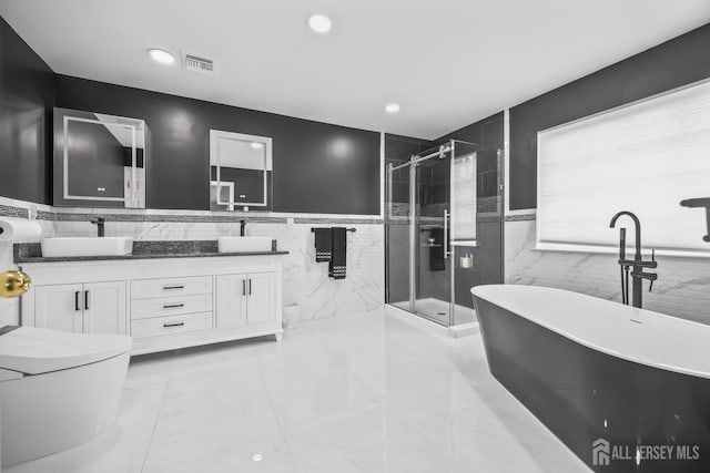 1004 Antoinette Dr, Monroe, NJ 08831 - bathroom featuring tile walls, double vanity, a freestanding tub, marble finish flooring, and a shower stall