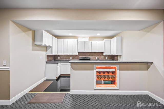 1004 Antoinette Dr, Monroe, NJ 08831 - kitchen with dark countertops, white cabinets, tasteful backsplash, recessed lighting, and a peninsula