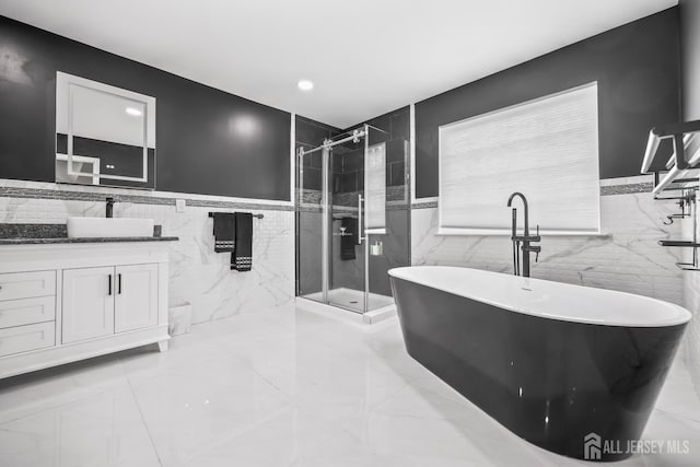 1004 Antoinette Dr, Monroe, NJ 08831 - full bathroom with tile walls, a shower stall, vanity, a freestanding bath, and a wainscoted wall