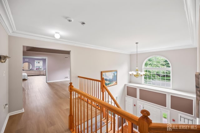1004 Antoinette Dr, Monroe, NJ 08831 - hall with ornamental molding, an upstairs landing, a chandelier, and wood finished floors