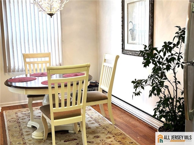 156 Pelham Ln Unit 156N, Monroe, NJ 08831 - dining space with wood finished floors, healthy amount of natural light, a chandelier, and baseboards