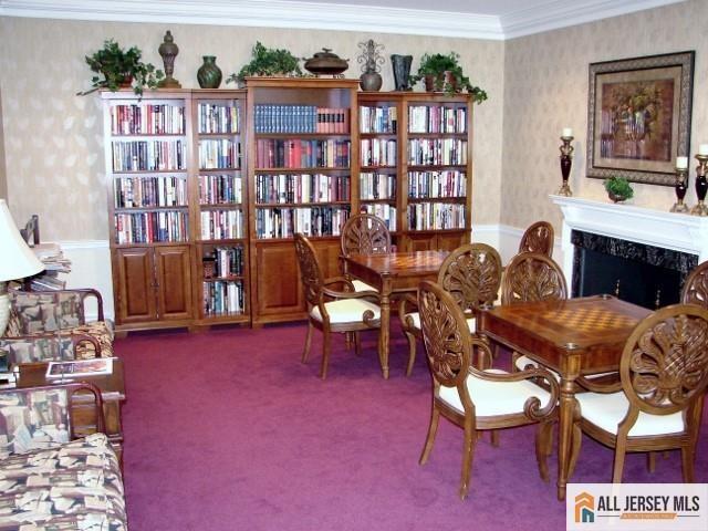 156 Pelham Ln Unit 156N, Monroe, NJ 08831 - living area featuring wallpapered walls, ornamental molding, wainscoting, carpet floors, and a premium fireplace