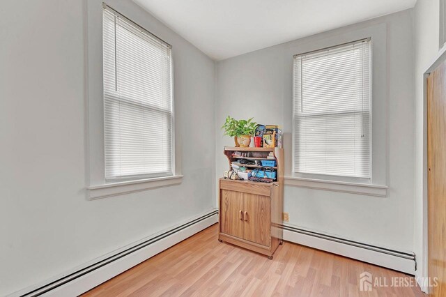 interior space featuring a baseboard radiator and a healthy amount of sunlight