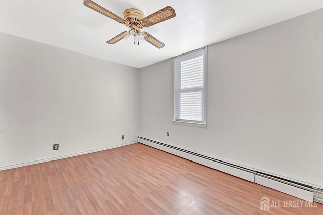 unfurnished room featuring a baseboard heating unit, ceiling fan, and light hardwood / wood-style flooring