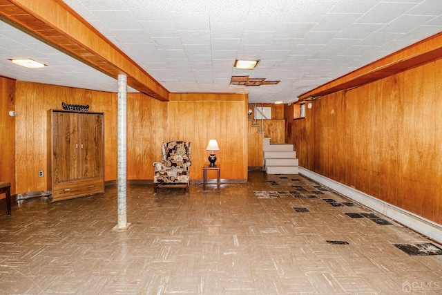 unfurnished room featuring wooden walls