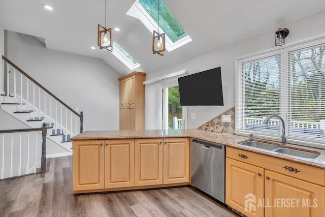 17 Thomas Rd, East Brunswick, NJ 08816 - kitchen with stainless steel dishwasher, a skylight, light brown cabinets, lofted ceiling, and recessed lighting