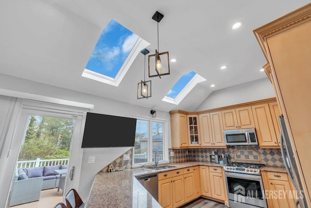17 Thomas Rd, East Brunswick, NJ 08816 - kitchen with stainless steel appliances, a skylight, healthy amount of natural light, lofted ceiling, and light brown cabinets