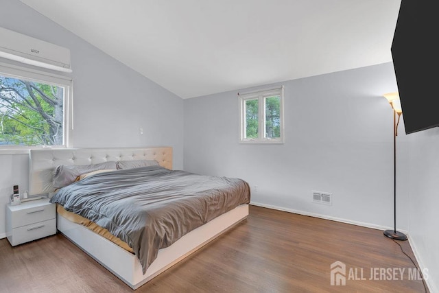 17 Thomas Rd, East Brunswick, NJ 08816 - bedroom with lofted ceiling, wood finished floors, and a wall mounted AC