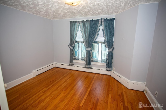 unfurnished room featuring hardwood / wood-style flooring