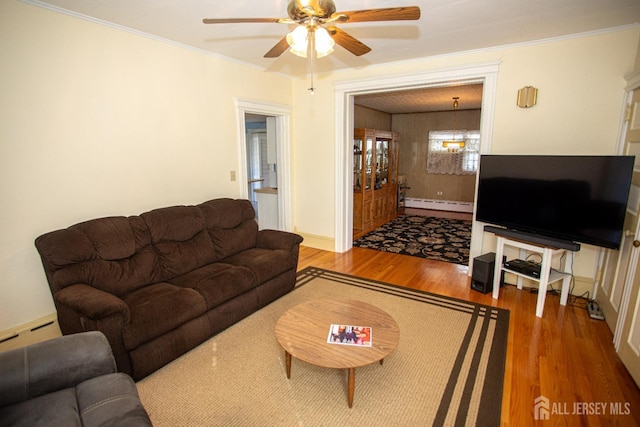 living room with hardwood / wood-style floors, crown molding, ceiling fan, and a baseboard heating unit