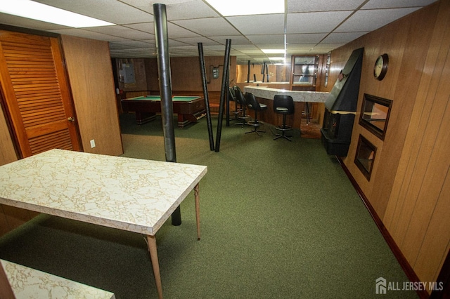 basement featuring bar area, wood walls, carpet, and pool table