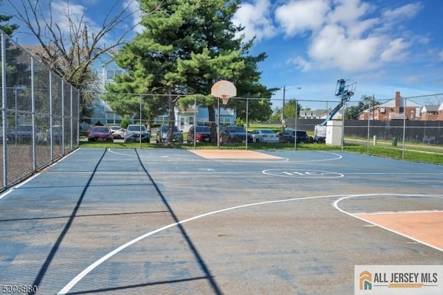 view of basketball court with community basketball court and fence