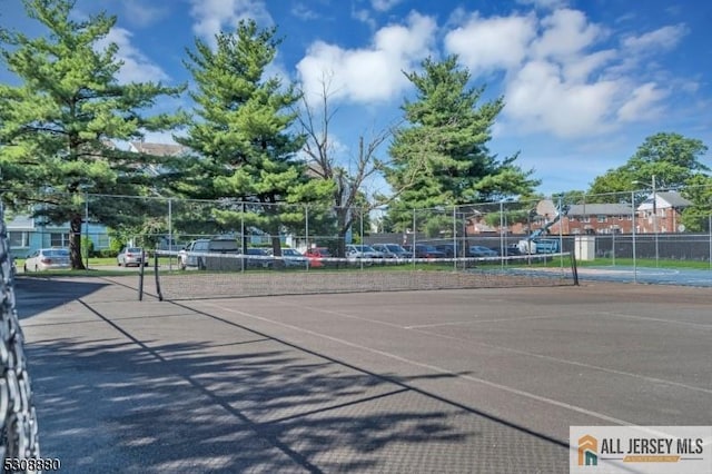 view of tennis court with fence