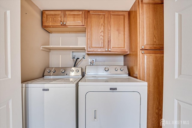 washroom with cabinet space and independent washer and dryer