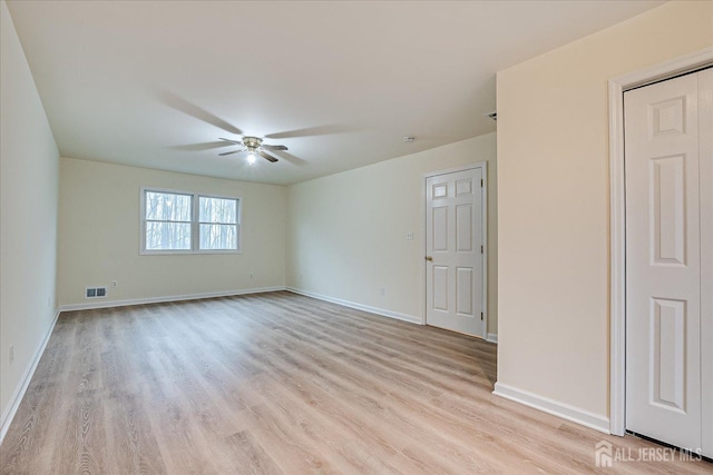 empty room featuring visible vents, baseboards, light wood-style floors, and a ceiling fan