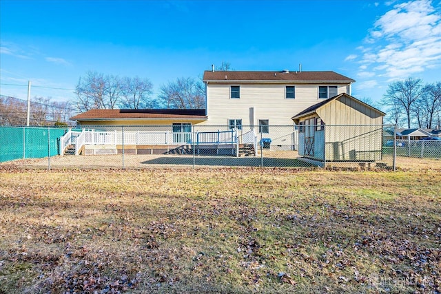 back of property with a lawn and a fenced backyard