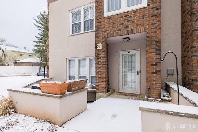 view of snow covered property entrance