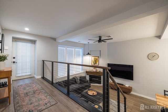 corridor featuring hardwood / wood-style flooring and beam ceiling