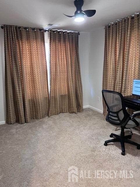 unfurnished office featuring baseboards, ceiling fan, and carpet flooring