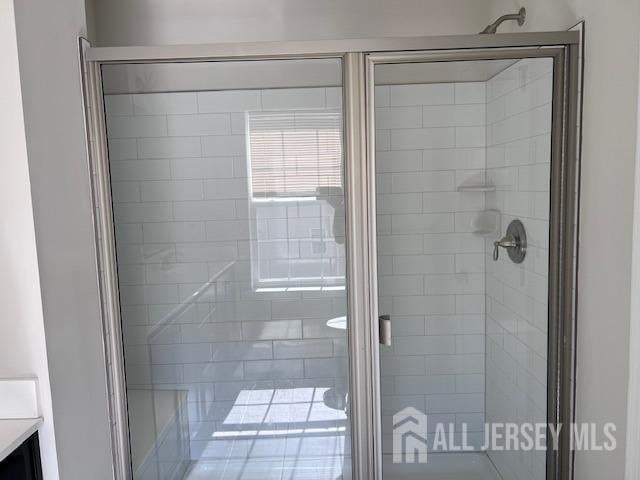 bathroom with vanity and a stall shower