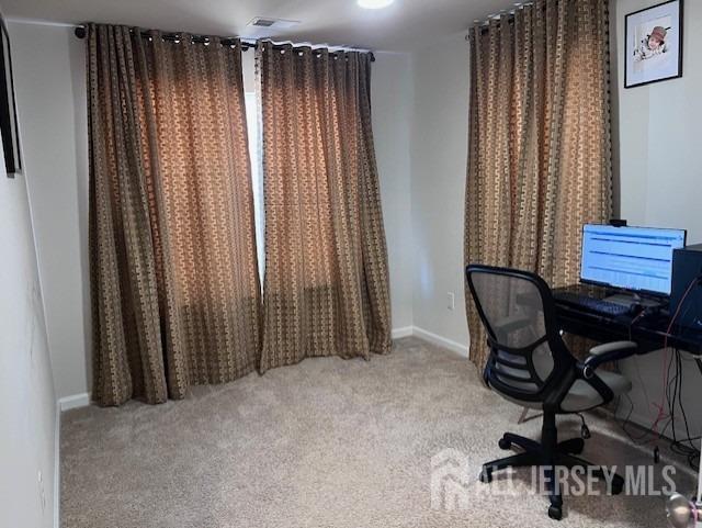 carpeted office featuring baseboards