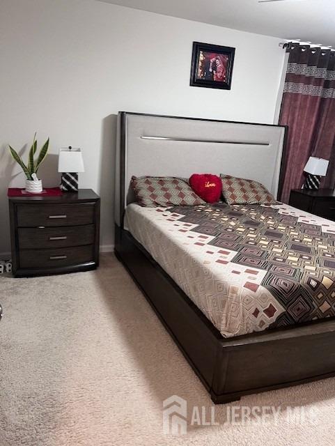 bedroom featuring light colored carpet